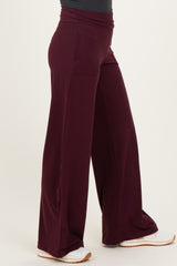 woman wearing burgundy wide-leg lounge pants with side pockets