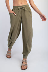 woman wearing olive green textured drawstring pants with side pockets and relaxed fit