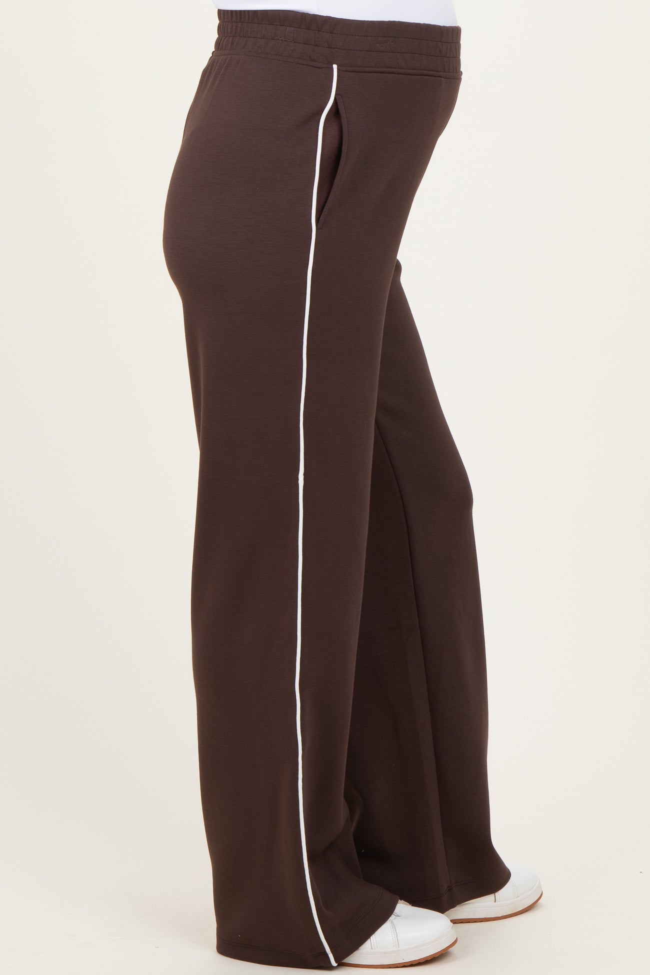woman wearing brown maternity jogger pants with white side stripes and a comfortable elastic waistband