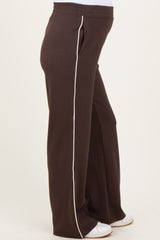 woman wearing brown maternity jogger pants with white side stripes and a comfortable elastic waistband