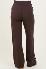 brown maternity joggers with a wide-leg fit and white side stripes, shown from the back