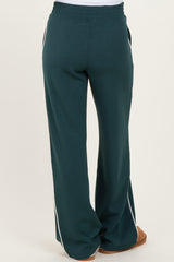 woman wearing green maternity sweatpants with side stripes, showing the back view