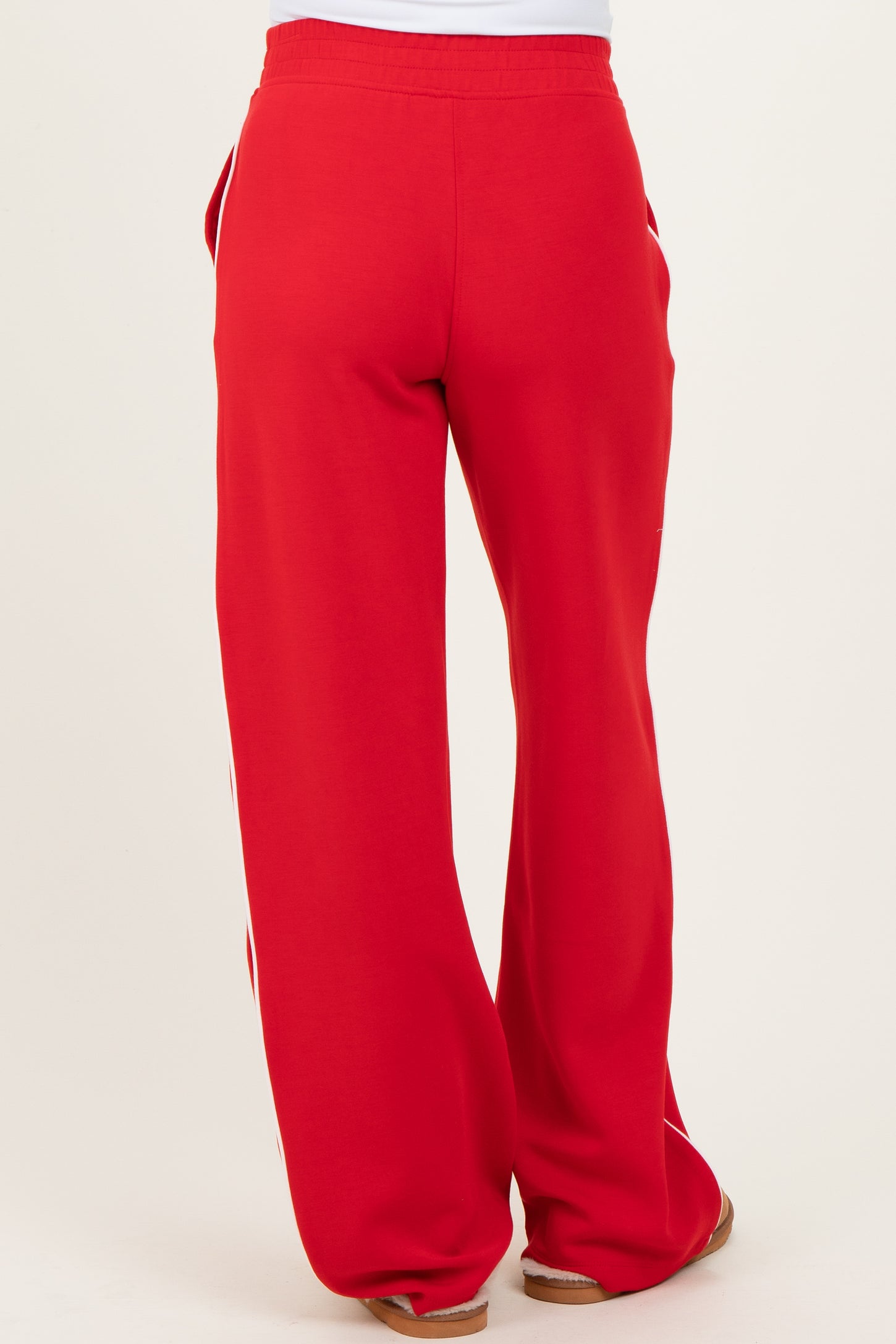 woman wearing red maternity sweatpants, showing the back view with a relaxed fit and side pockets