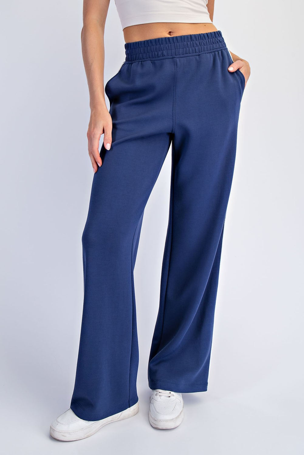 woman wearing navy blue wide-leg lounge pants with an elastic waistband and pockets