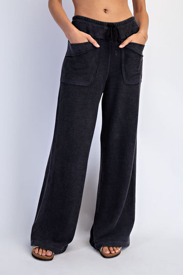 woman wearing black corduroy wide-leg pants with front pockets and a drawstring waist