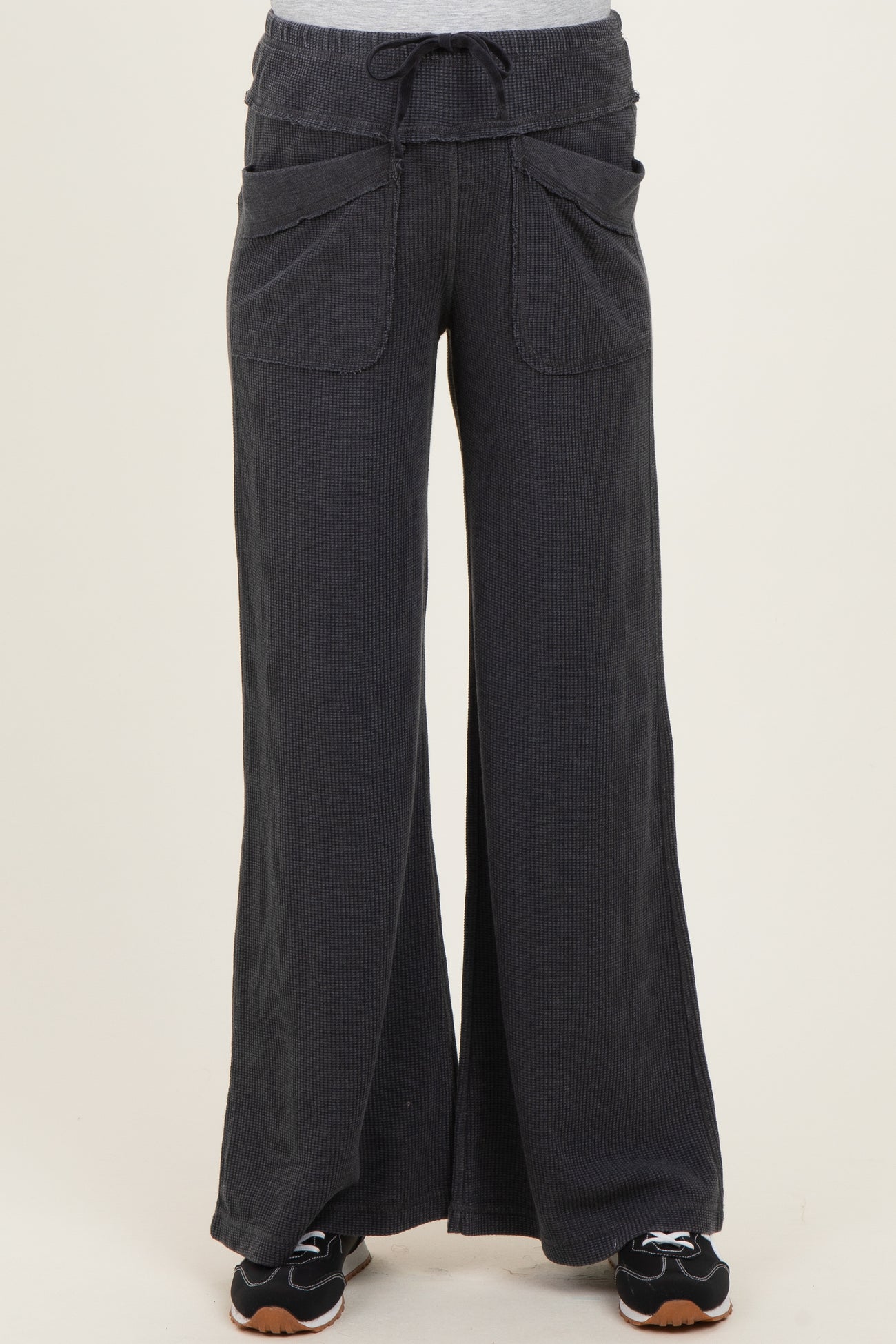 maternity wear in dark gray wide-leg pants with drawstring and front pockets, styled with a casual top