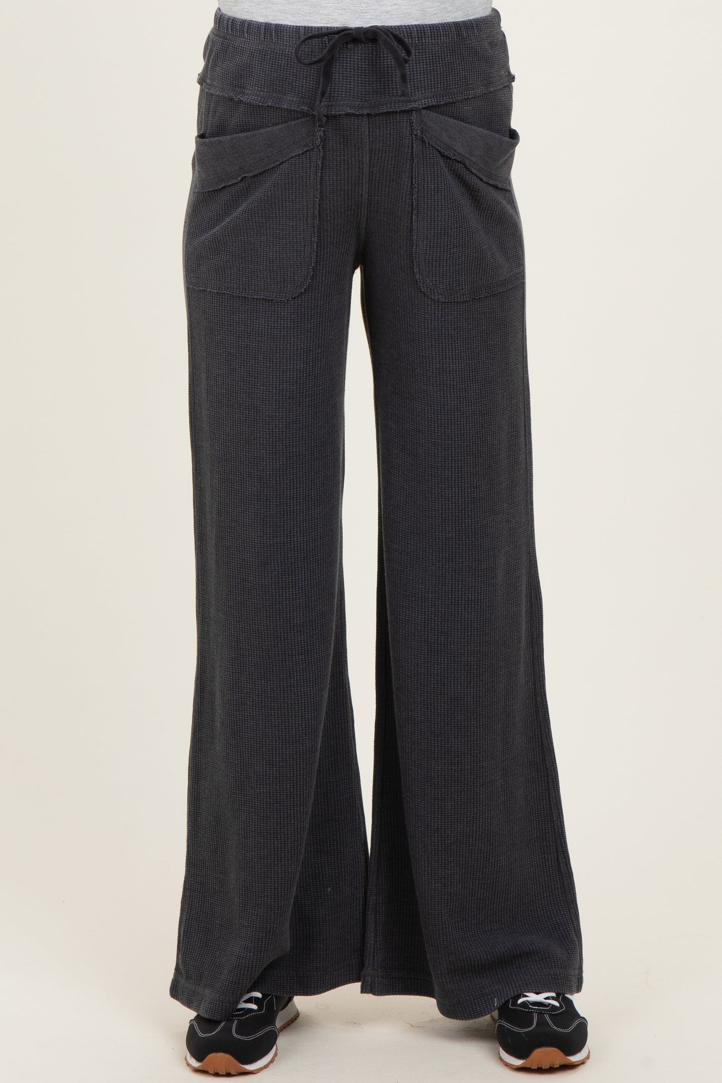 maternity wear in dark gray wide-leg pants with drawstring and front pockets, styled with a casual top