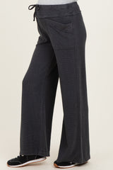 woman wearing dark gray maternity wide-leg pants with side pockets and a drawstring waist