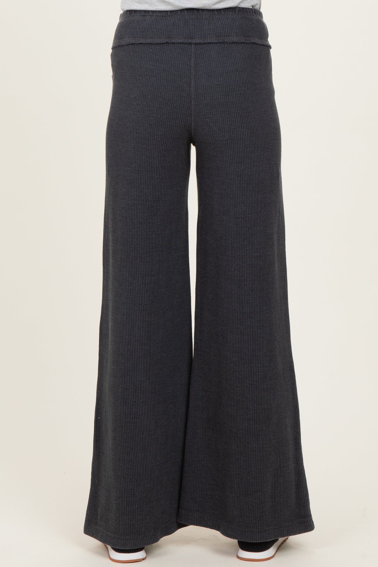 woman wearing dark gray wide leg maternity pants, shown from the back