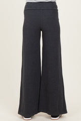 woman wearing dark gray wide leg maternity pants, shown from the back