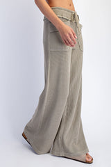woman wearing light olive ribbed wide-leg pants with a drawstring waistband and front pockets