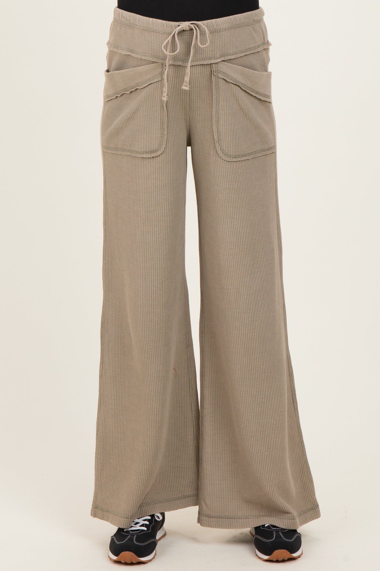 woman wearing beige ribbed wide-leg maternity pants with pockets and a drawstring waistband