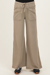woman wearing beige ribbed wide-leg maternity pants with pockets and a drawstring waistband