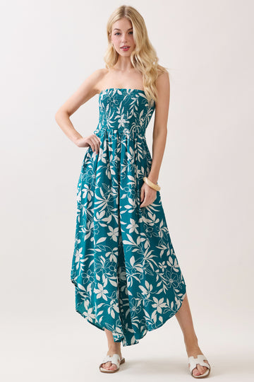 woman wearing a strapless teal floral maxi dress with a high-low hem and a smocked bodice