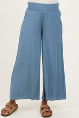 maternity wear in light blue wide-leg pants with smocked waistband, model wearing brown sandals
