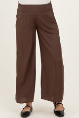 woman wearing brown maternity wide-leg pants with a smocked waistband