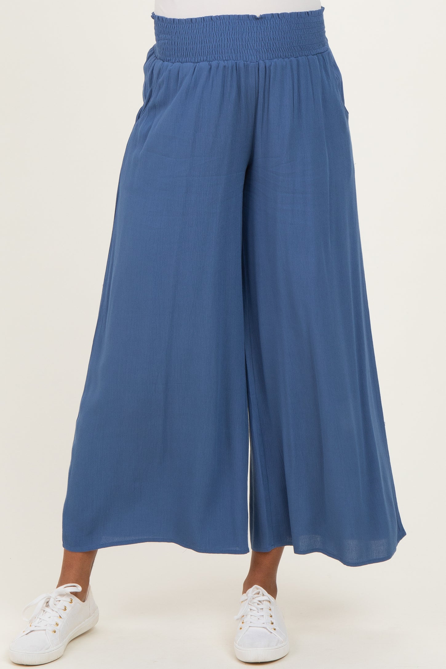 woman wearing blue maternity wide-leg pants with an elastic waistband and side pockets