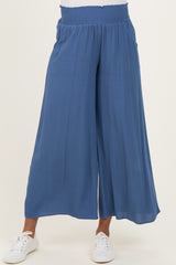 woman wearing blue maternity wide-leg pants with an elastic waistband and side pockets