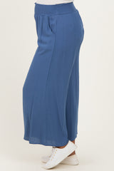 maternity wear in a deep blue wide-leg pant with an elastic waistband, styled with white sneakers