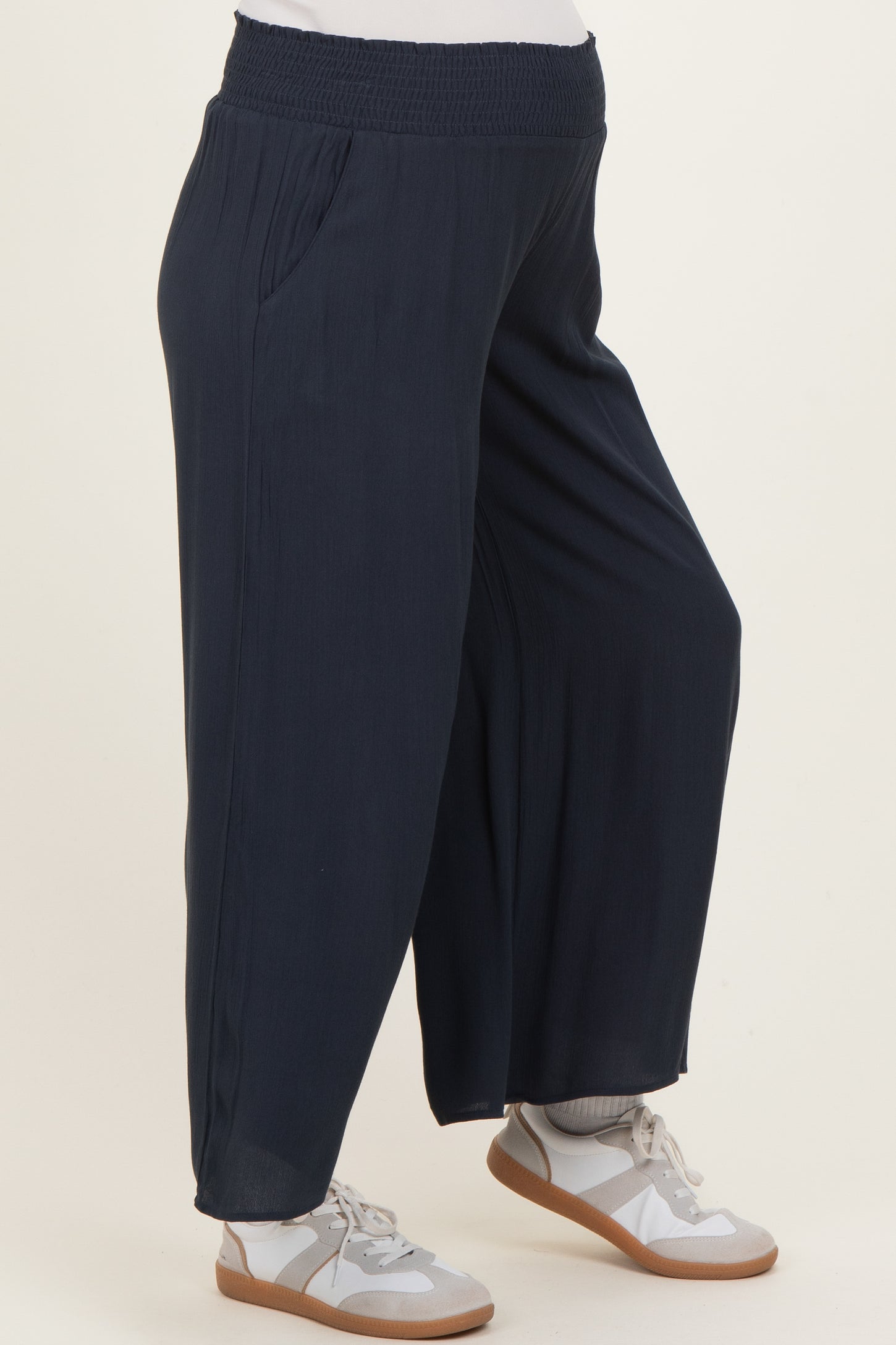 maternity wear in navy blue wide-leg pants with an elastic waistband and side pockets worn by a model