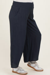 maternity wear in navy blue wide-leg pants with an elastic waistband and side pockets worn by a model
