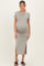 woman wearing a gray short sleeve maternity dress with a side slit and showing her baby bump