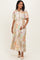 woman wearing a multi-colored floral maternity dress with short sleeves and a tie waist, holding her baby bump