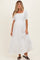 woman wearing a white maxi maternity dress with short puff sleeves and a smocked bodice, showing her baby bump