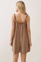woman wearing a back view of a taupe striped romper with ruffled straps