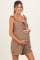 woman wearing a brown striped maternity dress with ruffled straps and a tied neckline, showing her baby bump