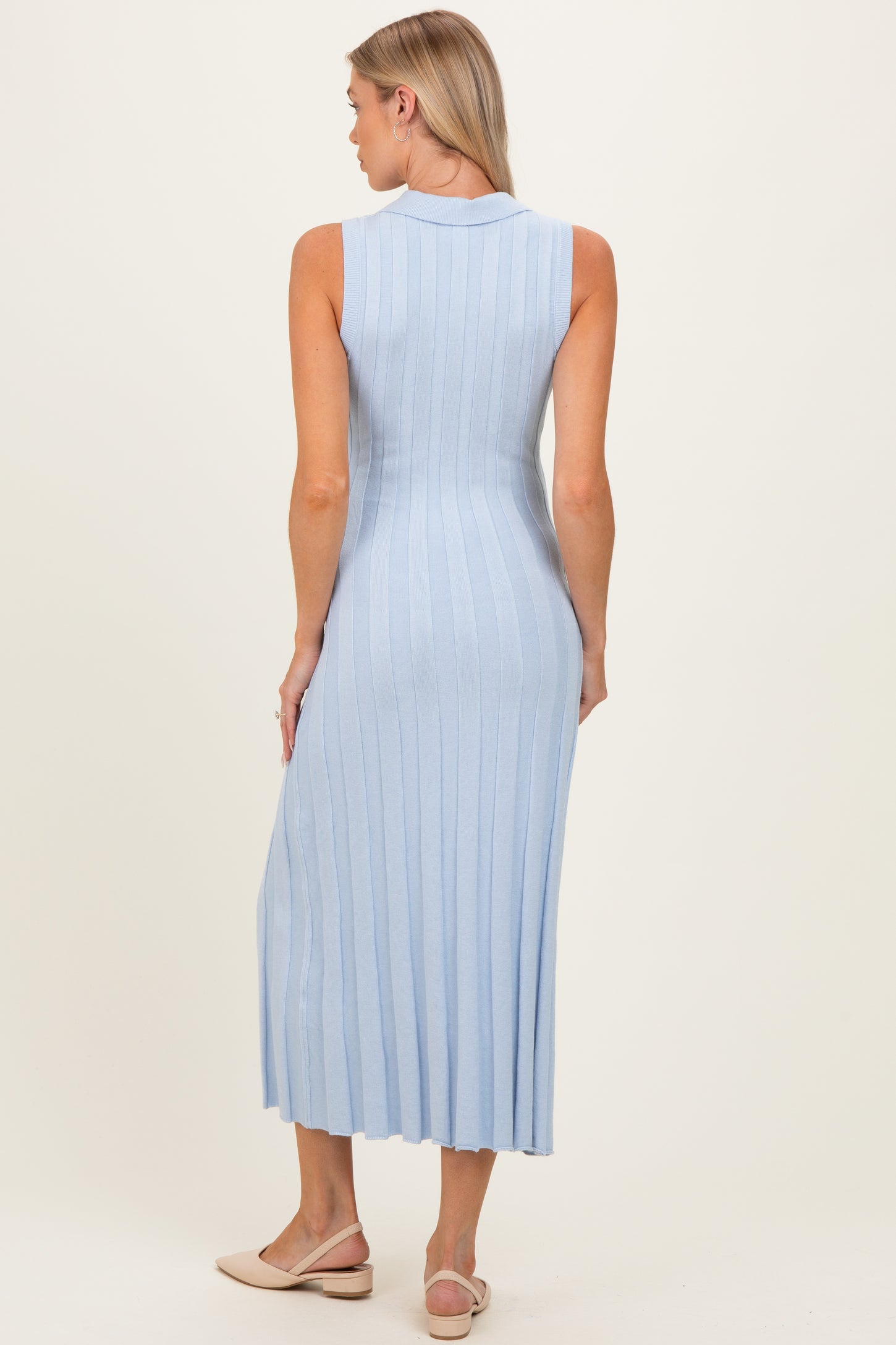 woman wearing a light blue sleeveless ribbed maternity dress that falls to mid-calf