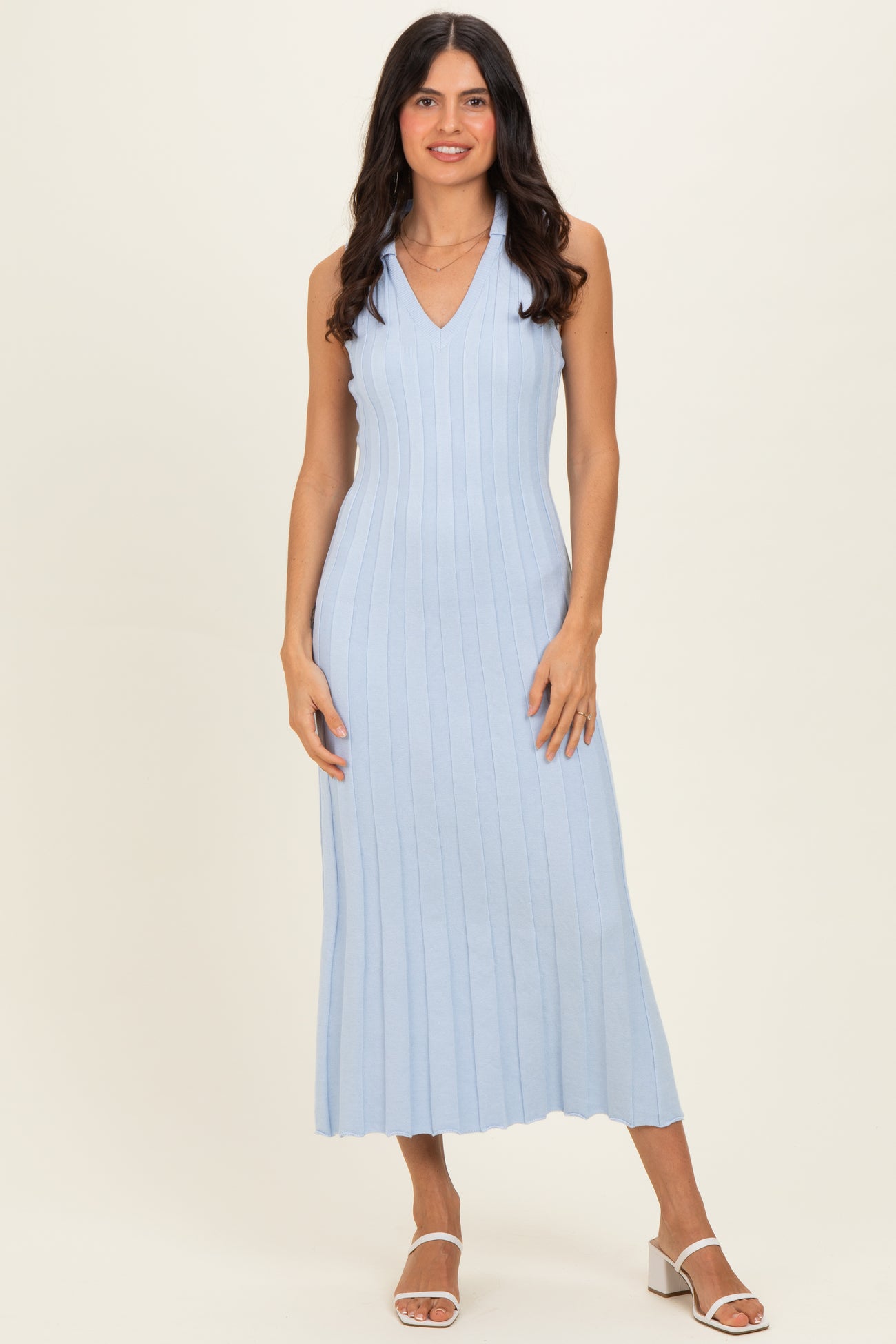 woman wearing a light blue ribbed sleeveless midi dress with a v-neckline and side slits