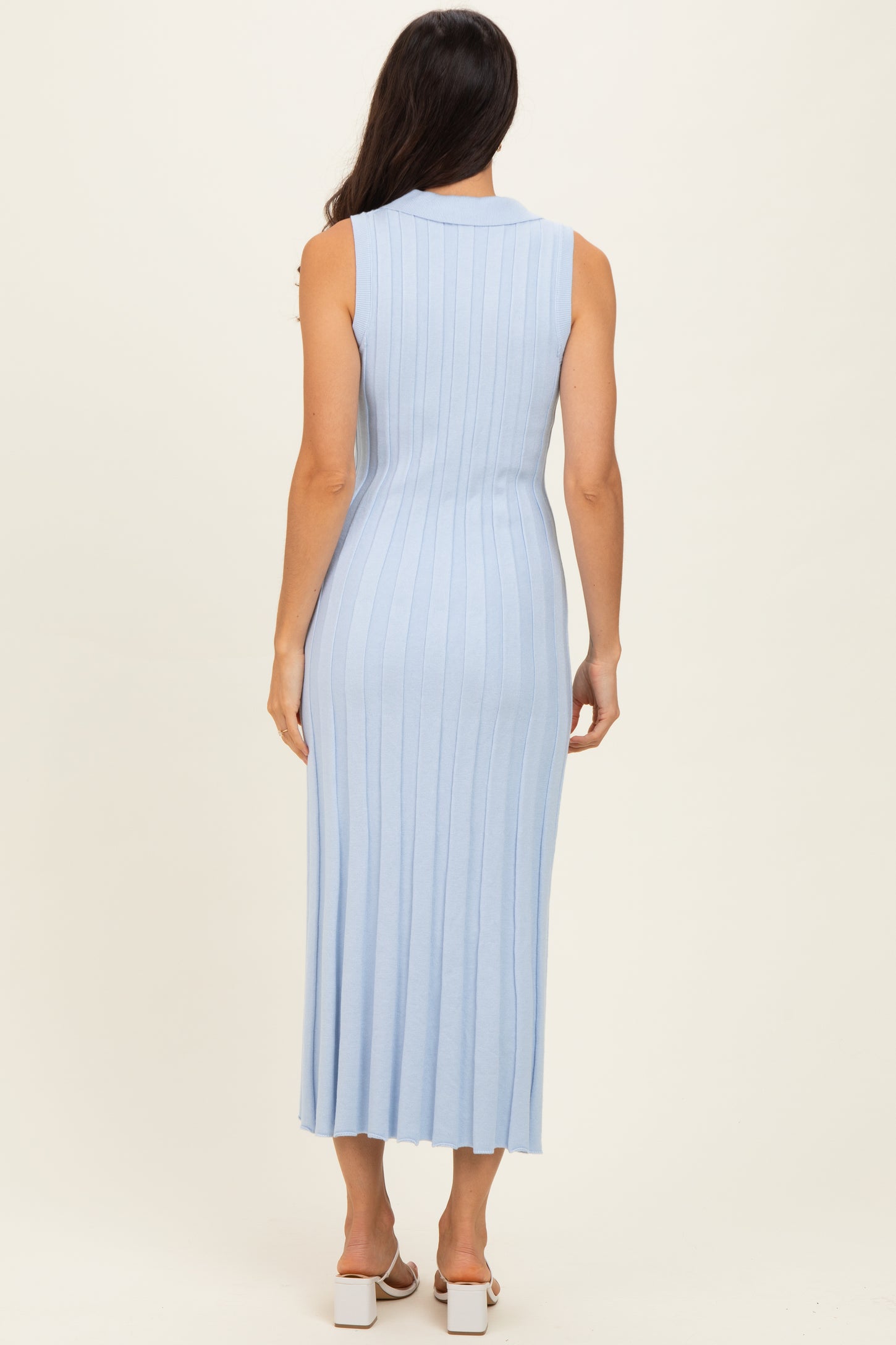 woman wearing a light blue ribbed knit sleeveless maxi dress with a collar and a fitted silhouette