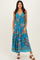 woman wearing a blue floral maxi dress with a drawstring detail and a tiered hemline