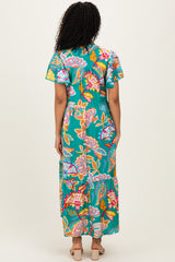 woman wearing a vibrant floral print maxi dress with short sleeves and a tiered skirt, shown from the back