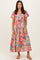 woman wearing a pink floral maxi dress with short flutter sleeves and v-neckline