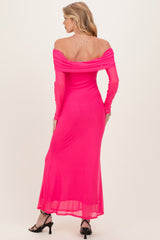 woman wearing a hot pink off-the-shoulder maternity dress with long sleeves and a flowing maxi skirt, showing her back