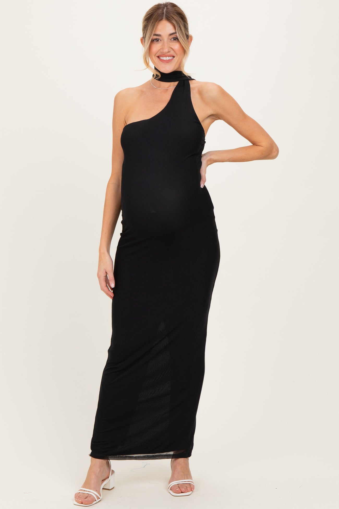 woman wearing a black one-shoulder maternity dress with a fitted style and a visible baby bump