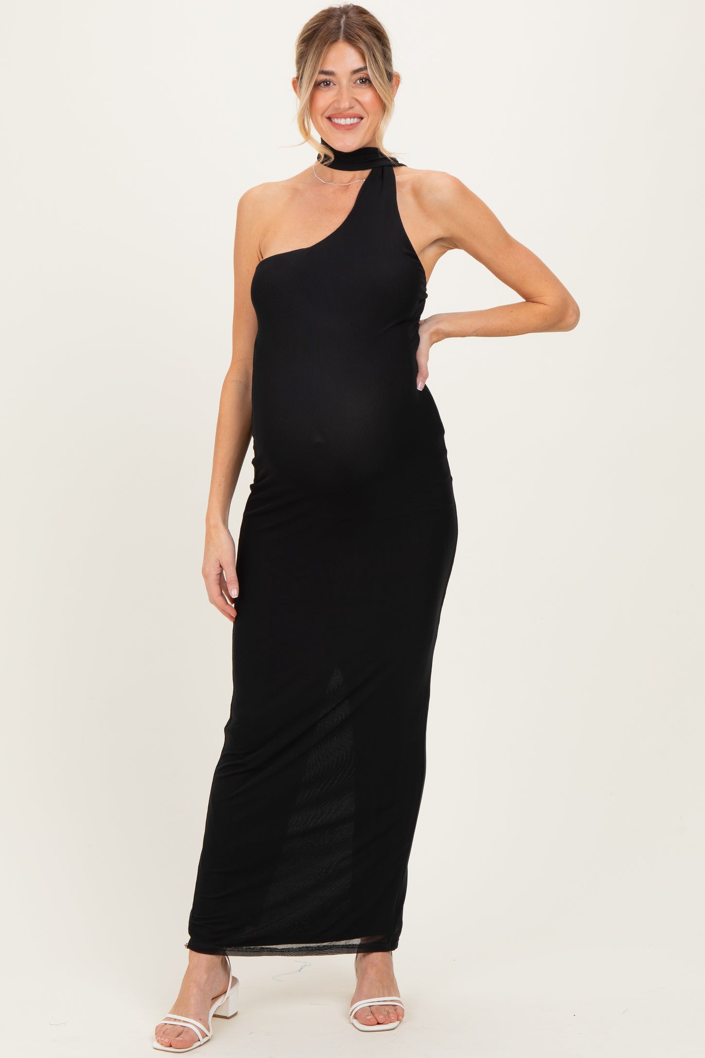 woman wearing a black one-shoulder maternity dress with a fitted style and a visible baby bump