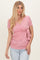 woman wearing a pink short sleeve wrap top with floral prints and a side tie detail