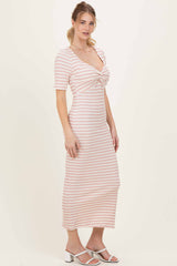 woman wearing a pink and white striped midi dress with short sleeves and a knotted detailing at the bust