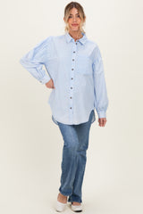 woman wearing a light blue maternity button-up shirt with puff sleeves and paired with jeans