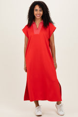 woman wearing a bright red short sleeve maxi dress with a v-neckline and side slits, styled with white sneakers