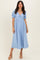 woman wearing a light blue, puff sleeve maxi dress with a twist front detail and a flowy silhouette