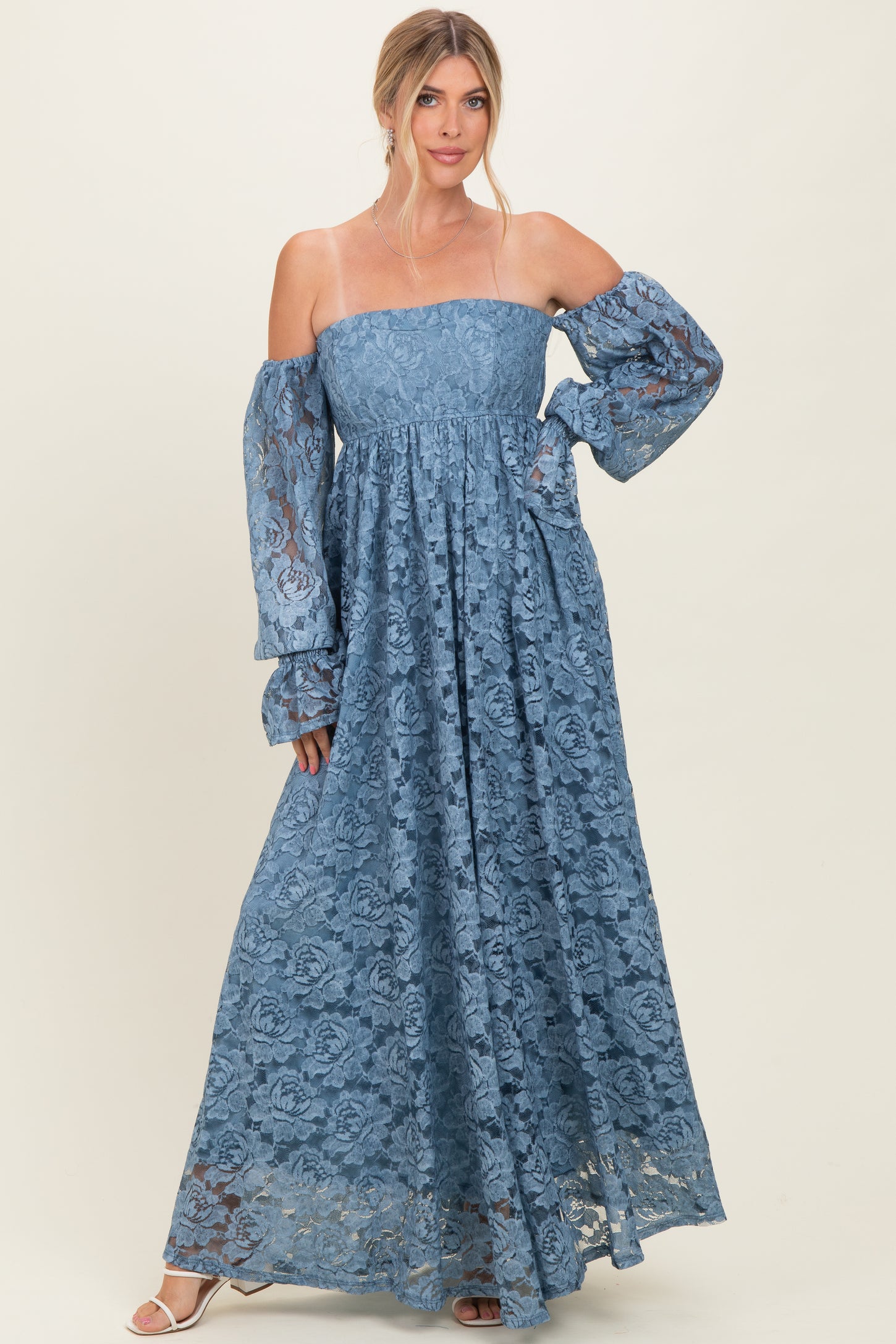 woman wearing a powder blue off-the-shoulder lace maxi dress with long balloon sleeves