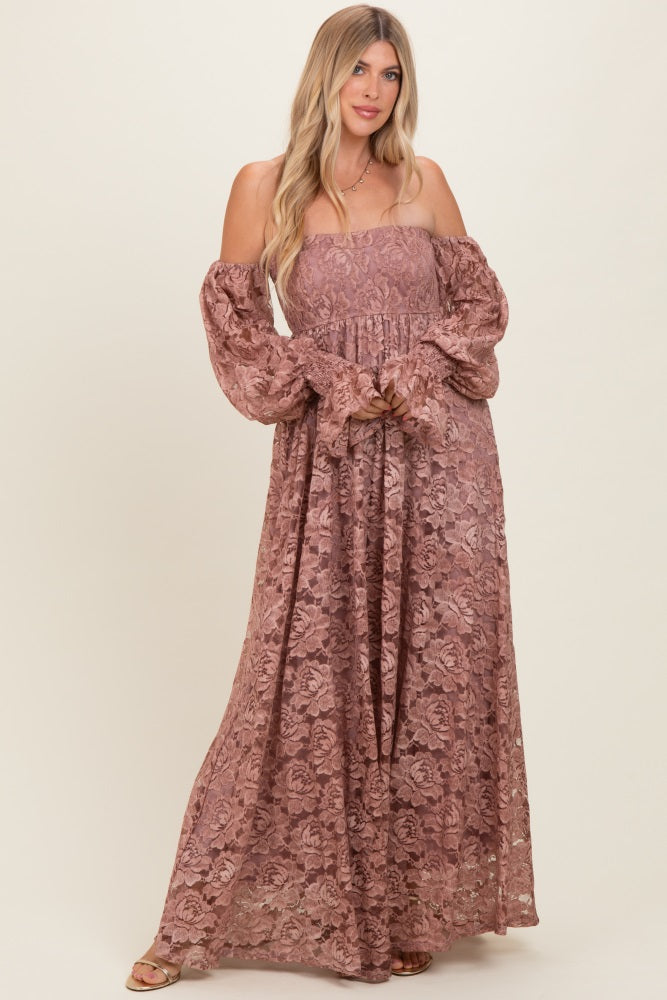 woman wearing a blush pink off-the-shoulder lace maxi dress with long puff sleeves and a fitted bodice