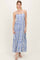 woman wearing a blue and white patterned maxi dress with spaghetti straps and a tiered skirt