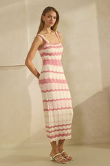 woman wearing a striped pink and white knitted dress with a fitted silhouette and spaghetti straps