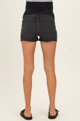 woman wearing black maternity denim shorts with a stretchy waistband, showing the back view