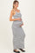 woman wearing a black and white striped maternity maxi dress and holding her baby bump
